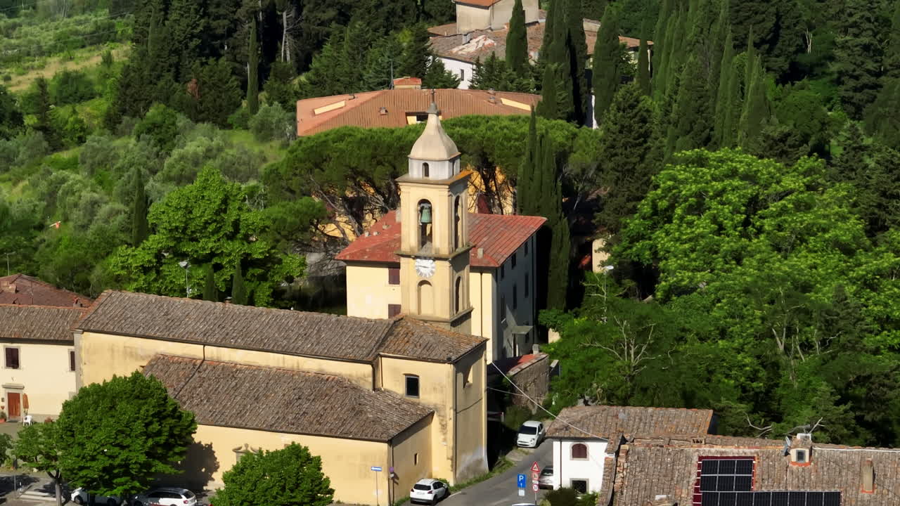 Telephoto drone shot around the Chiesa di Santa Maria church, in Marcialla, Italy