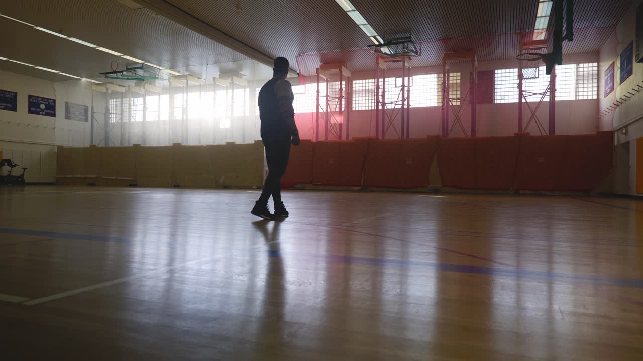 Male Walking Onto Court and Looking Around - Strong Athletic Muscular Black Man Standing On Basketball Court Looking Around In 4K