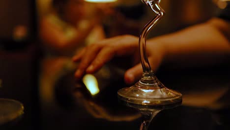 hand interacting with a reflective glass object
