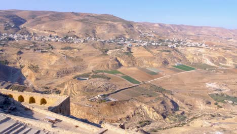 Aerial-landscape-view-of-vast-Arabian-farming-agricultural-desert-terrain-in-Al-Karak-from-Kerak-Medieval-Castle-in-Jordan,-Middle-East