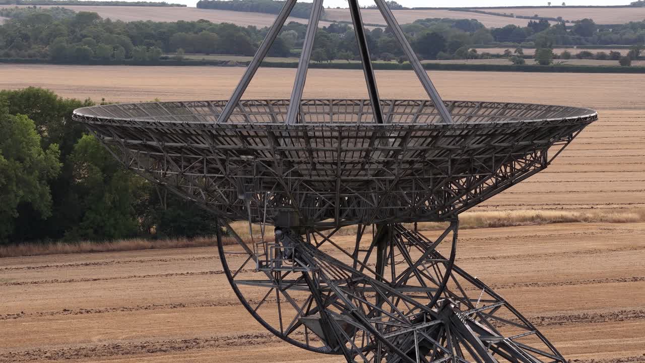 Rural landscape with large radio telescope at MRAO, England, daytime