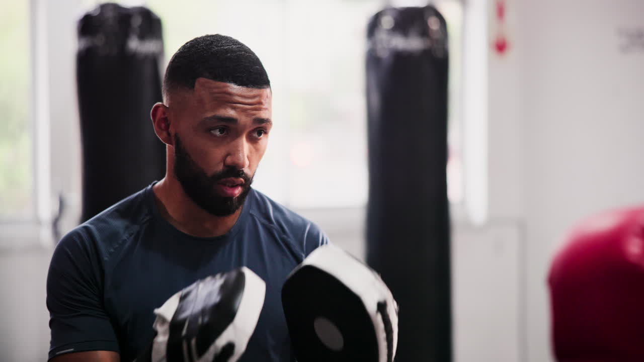 Man Boxing Training in a Gym