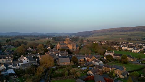 Aerial-footage-of-the-Medieval-village-of-Cartmel-in-the-English-Lake-District-it-has-a-rich-heritage,-and-varied-list-of-activities-for-visitors-and-tourists