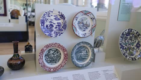 display of asian art plates in museum setting