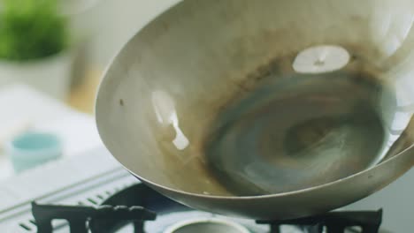 Woman-spreading-oil-on-frying-pan-before-cooking