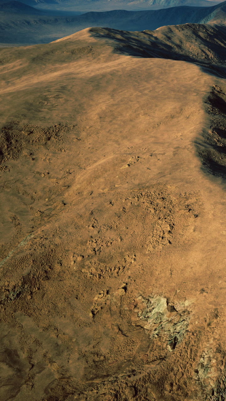 Vast arid landscape stretches under the sun on a clear day in rugged terrain