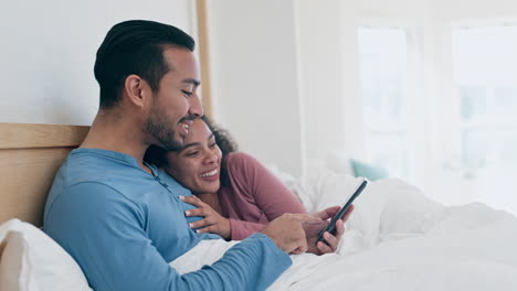 Happy,-bed-and-interracial-couple-with-a-phone