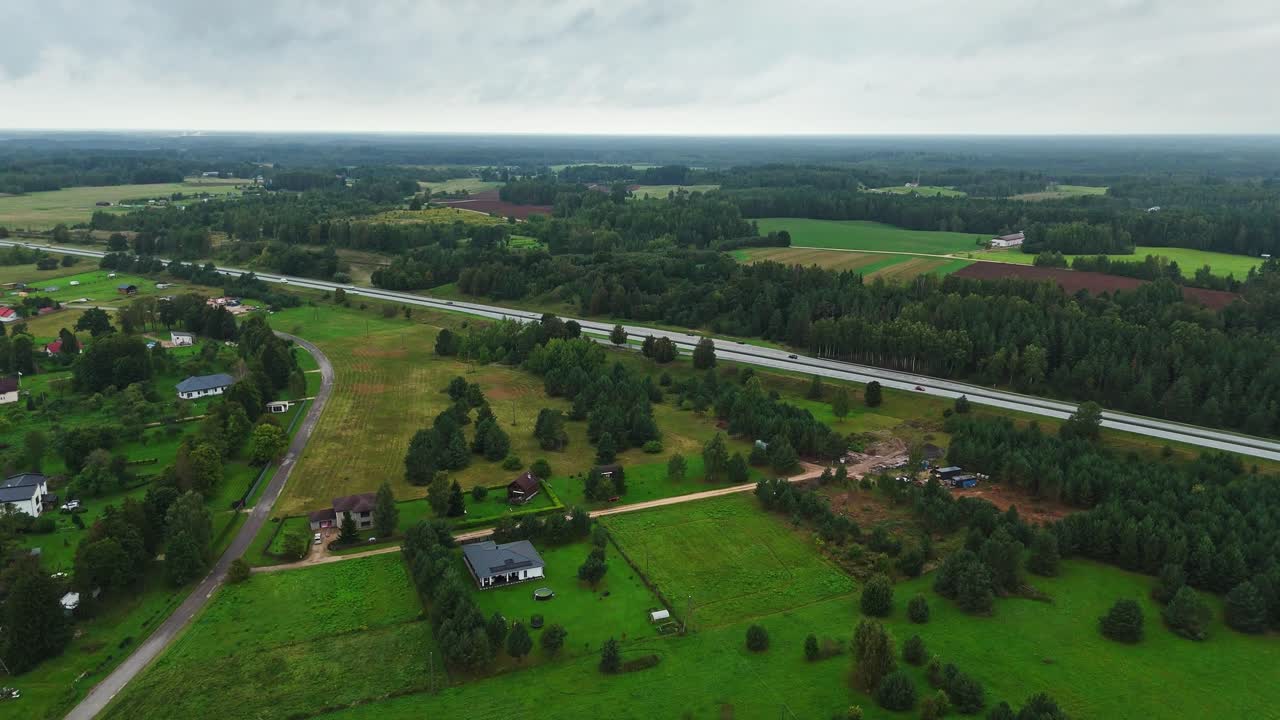 Aerial view of Ikskile rural landscape, lush fields, and serene roads