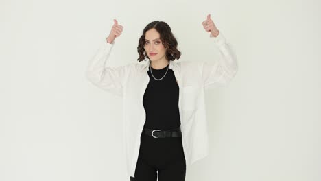 young woman in casual outfit posing and giving thumbs up on white background