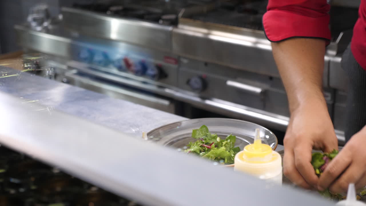 Chef preparing salad in a restaurant kitchen