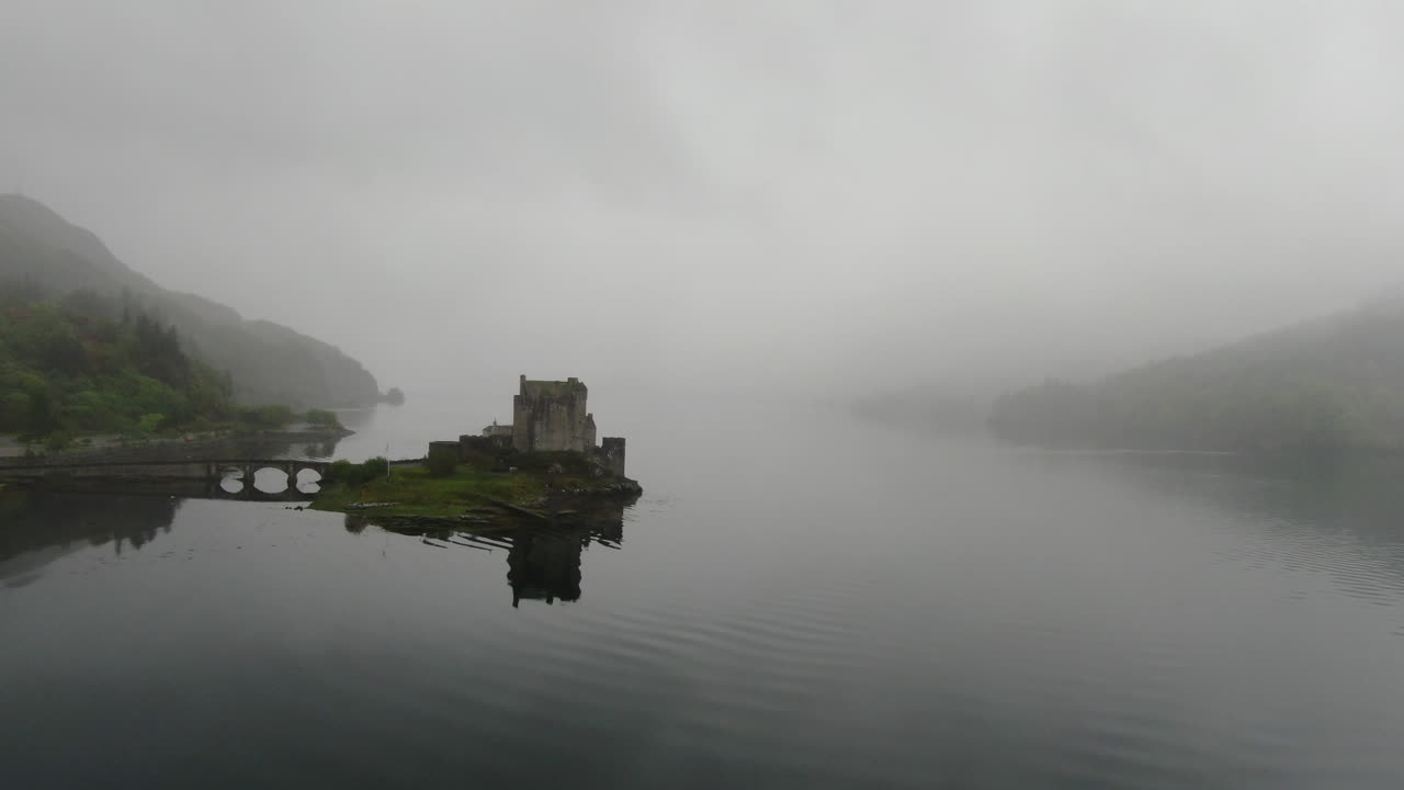 Foggy aerial views of Eilean Donan Castle in Scotland