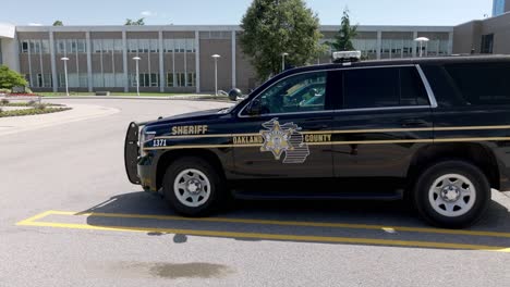 oakland county sheriff vehicle in michigan with gimbal video walking forward