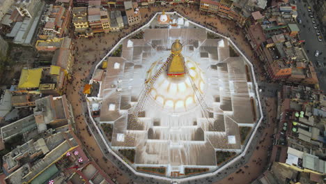 Boudha-Stupa-of-Nepal-in-stunning-Aerial-4k-Drone-Shot-at-Kathmandu-Golden-Hour,-revealing-Peaceful-Buddhist-Prayer