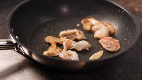 shrimp and mushrooms frying in pan