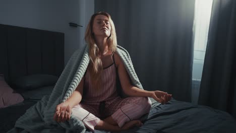 woman meditating in bed in the morning