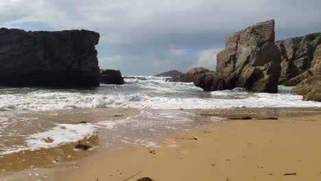 waves on the beach with big rocks in quiberon, brittany france