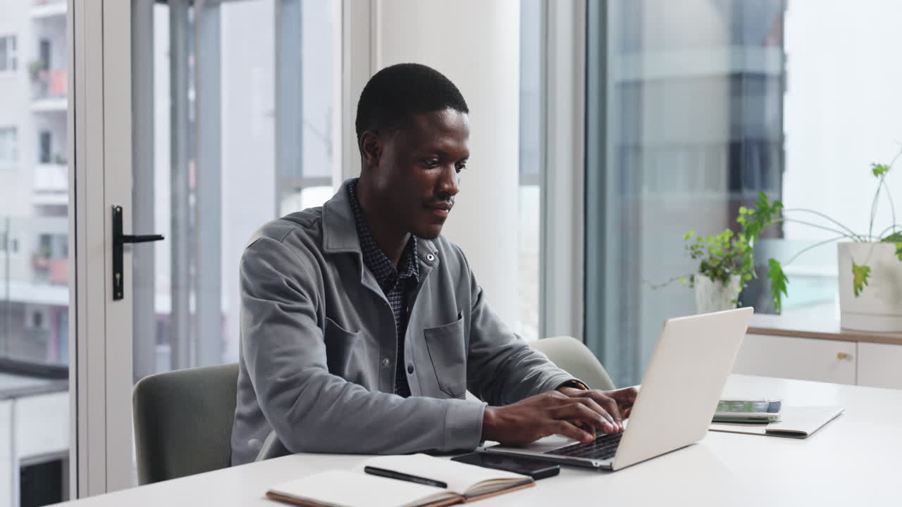 Man working on laptop in modern office