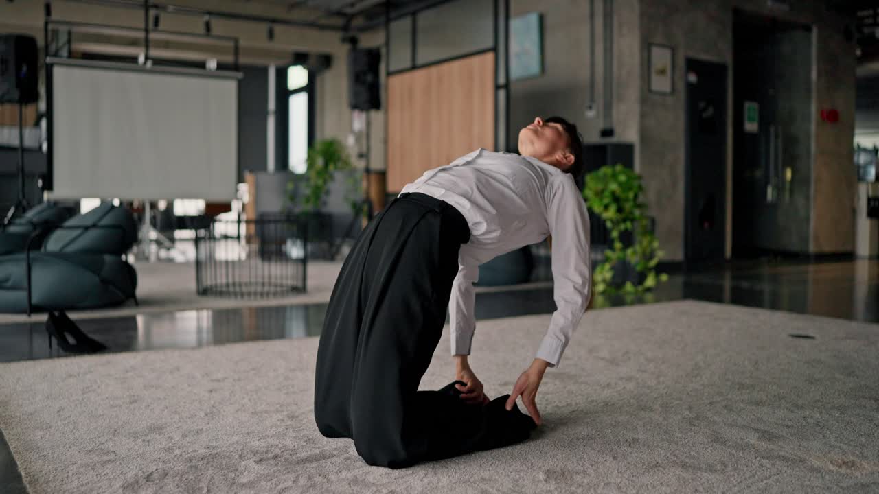 Businesswoman practicing yoga in office