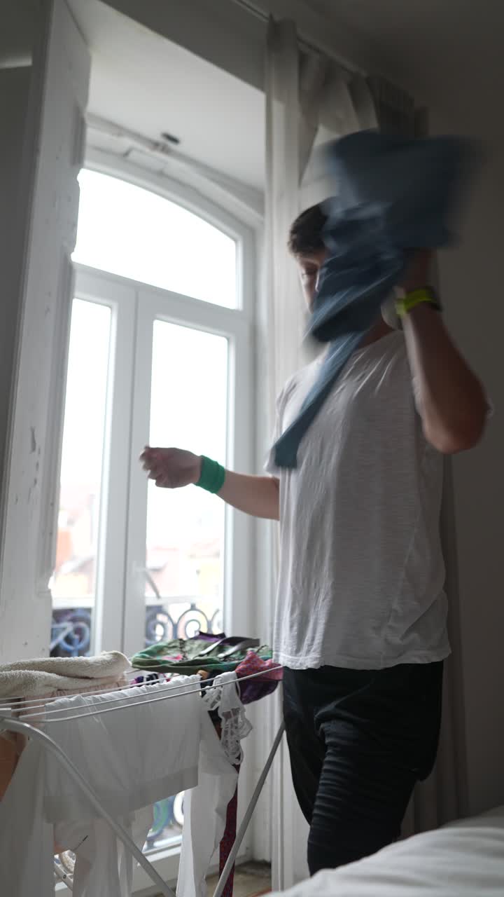 Person doing laundry in a bedroom