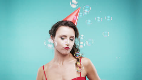 Crazy-face-drunk-woman-dancing-in-bubble-shower-slow-motion-photo-booth-blue-background