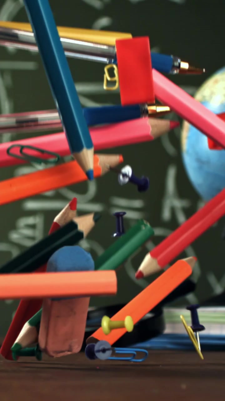 Colorful School Supplies Falling in Slow Motion on a Classroom Desk