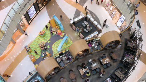 overhead shot of chinese shoppers enjoying their evening as they pastime at a shopping mall in hong kong