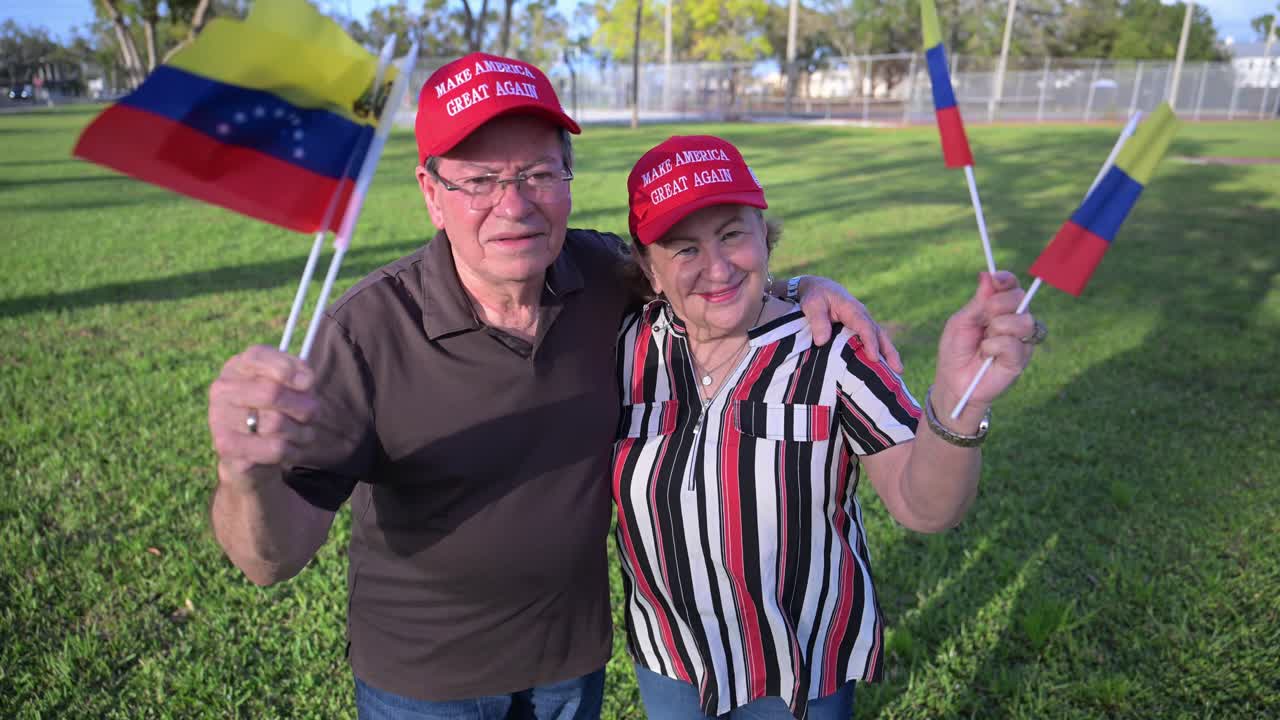 happy Venezueland immigrant couple wave Venezuelan flags and hope for election results
