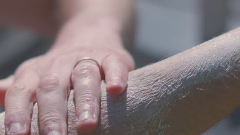suncream on hairy male arm being rubbed in to stop sunlight from causing sunburn to sensitive skin from harmful uv rays. dermatology prevention summer footage.