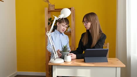 mother and son decorating table in home office