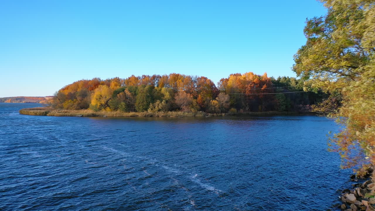 Autumn forest and river from air. Autumn in the wild on the background of the forest and the river
