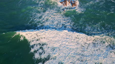 powerful ocean washing shoreline closeup. aerial stormy foam waves landscape