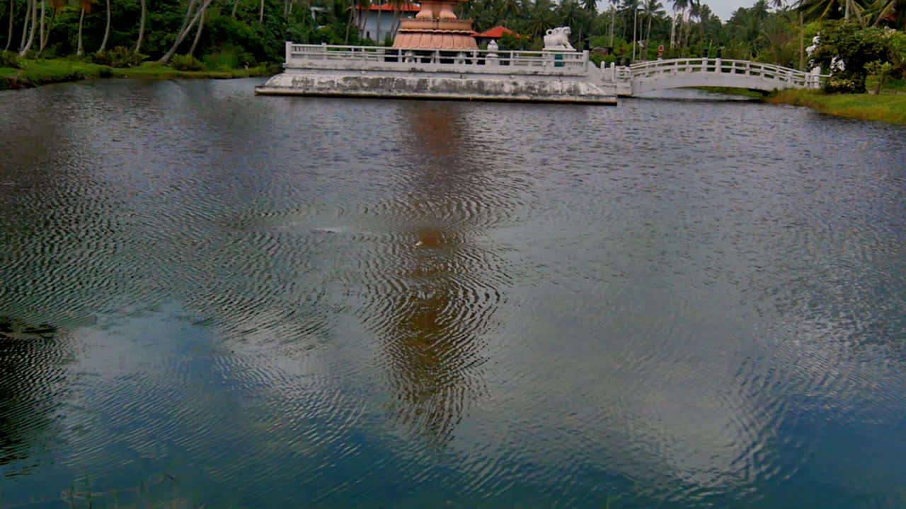 Gentle ripples across a calm lake reflecting the sky and subtle tree shadows in the water