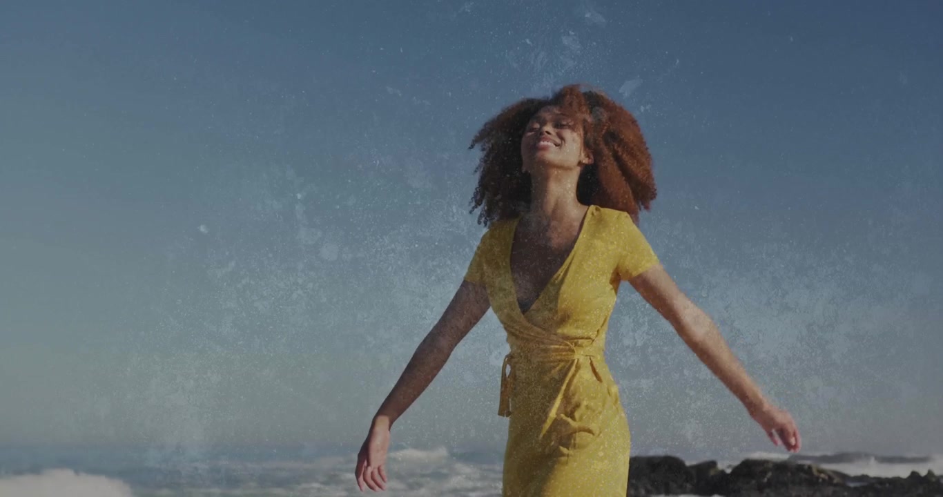 Young Woman in Yellow Dress Walking on Beach with Double Exposure Effect