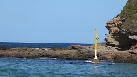 regular intervals of waves hitting a coastal beacon