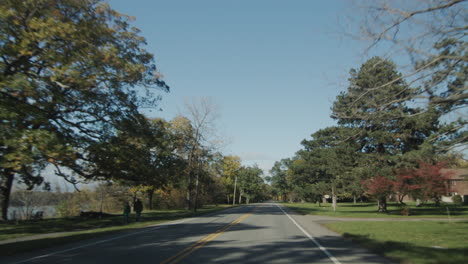 POV-View-from-the-window-of-a-car-that-drives-through-a-typical-American-suburb-in-the-state-of-New-York.-4k-video