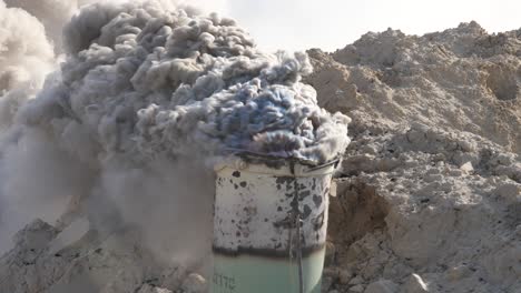 smoke from burning limestone in an iron barrel