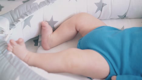 cute child bothers legs resting in sleeping cocoon closeup