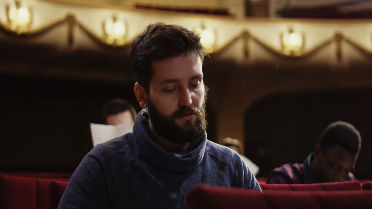 People Watching a Performance in a Theater