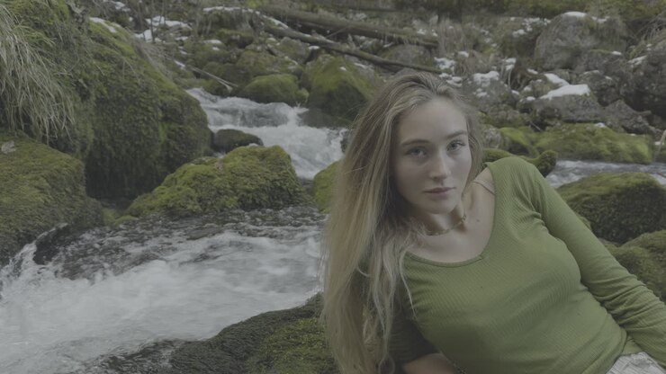Young Woman Relaxing by a Mountain Stream
