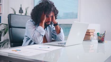 young african american man freelancer looks at laptop screen at office work