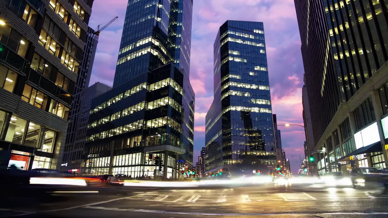 Dynamic cityscape video with a low-angle view of skyscrapers at dusk, capturing vibrant motion blur