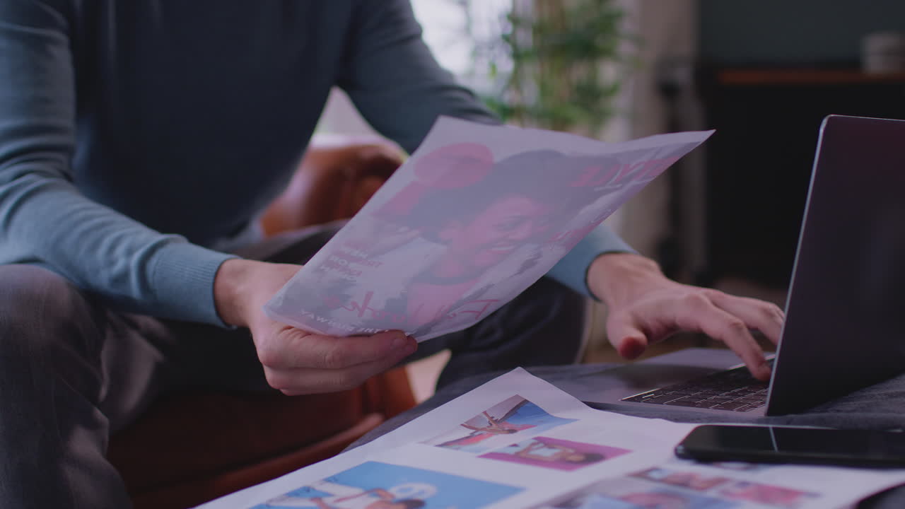 Close Up Of Man Working From Home In Creative Design Or Marketing Checking Artwork Design