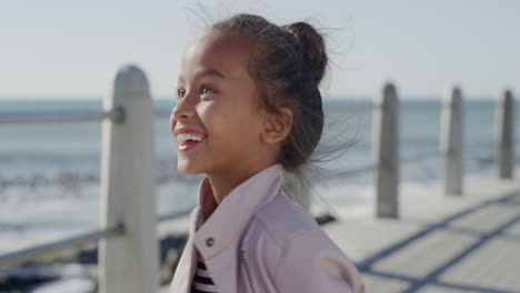 portrait little girl dancing excited laughing enjoying beautiful sunny day on seaside beach joyful summer vacation