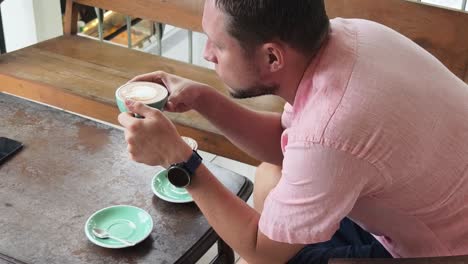 hombre disfrutando de café y postre en un café