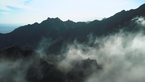 Enthralling-Revealing-Shot-of-Mountains-Covered-in-Rolling-Clouds,-Spain