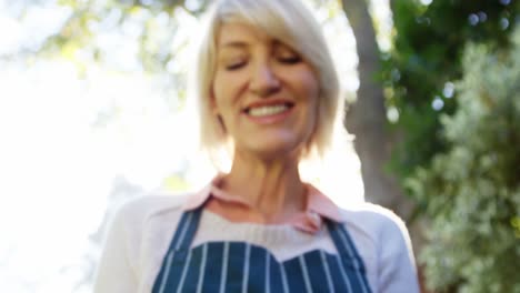 mature woman holding young plant