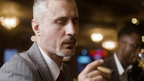 man smoking at the casino.