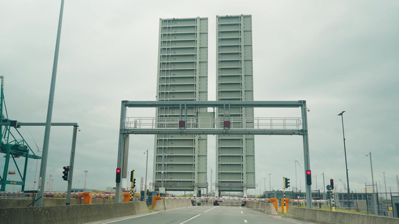Raised bridge at Kieldrechtsluis waiting for a large vessel arrival in the Port of Antwerp, with lock infrastructure visible - Antwerpen, Belgium