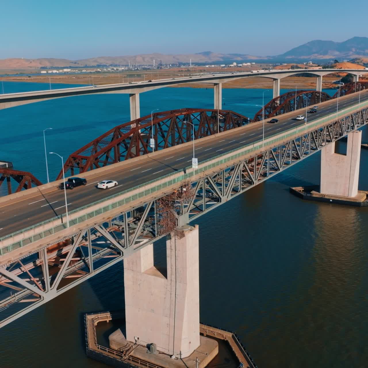 Bridges connecting Martinez to Benicia in California, United States. Mountainous landscape at backdrop. Clear sunny day backdrop