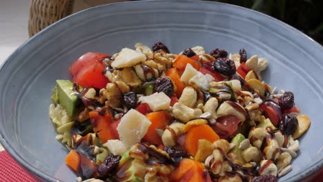 tazón de ensalada de verduras frescas con salsa balsámica y anacardos picados